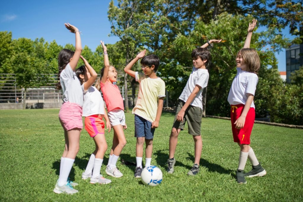 Group of kids enjoying a soccer game outdoors on a sunny day.
