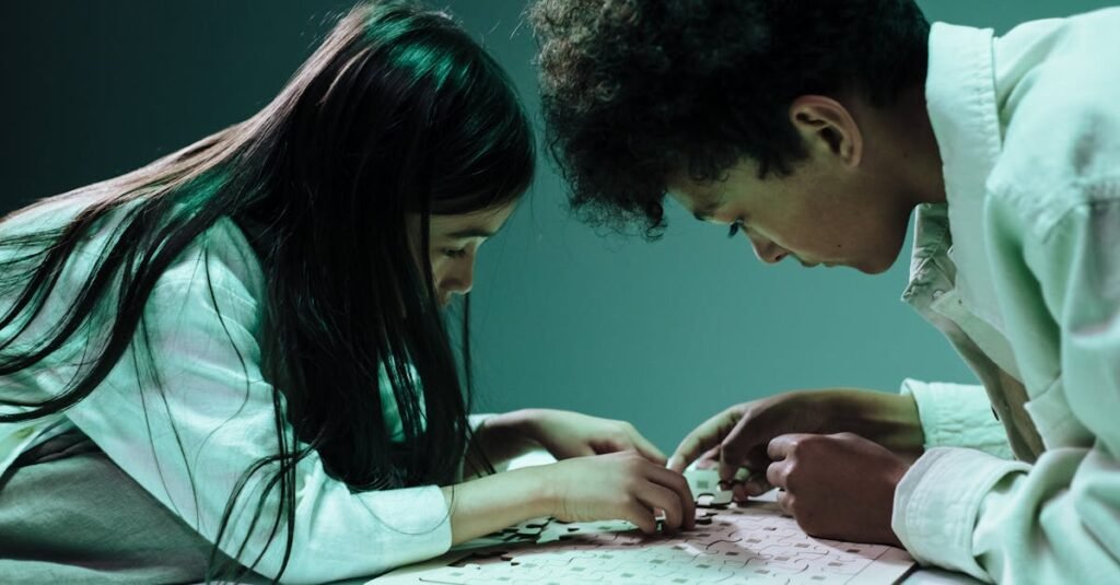 Two children focused on assembling a jigsaw puzzle indoors, fostering teamwork and concentration.