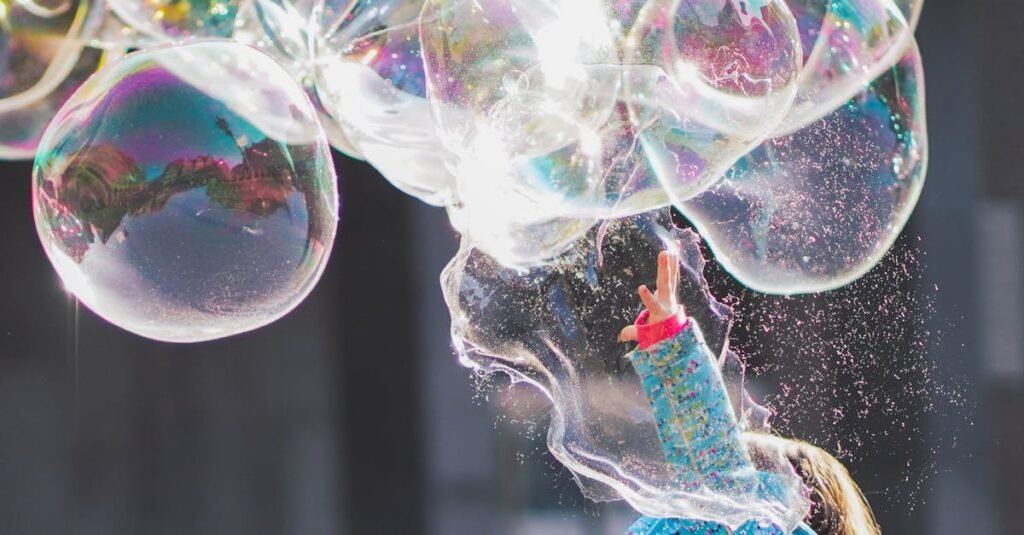A child delights in chasing and popping giant bubbles in an outdoor setting.